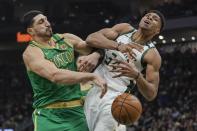 Boston Celtics' Enes Kanter fouls Milwaukee Bucks' Giannis Antetokounmpo during the first half of an NBA basketball game Thursday, Jan. 16, 2020, in Milwaukee. (AP Photo/Morry Gash)