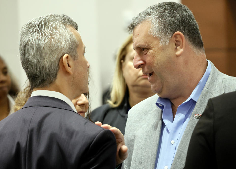 Tony Montalto speaks with Max Schachter during a break in closing arguments in the trial of former Marjory Stoneman Douglas High School School Resource Officer Scot Peterson, Monday, June 26, 2023, at the Broward County Courthouse in Fort Lauderdale, Fla. Peterson is accused of failing to confront the shooter who murdered 14 students and three staff members at a Parkland high school five years ago. Montalto's daughter, Gina, and Schachter's son, Alex, were killed in the 2018 shootings. (Amy Beth Bennett/South Florida Sun-Sentinel via AP, Pool)