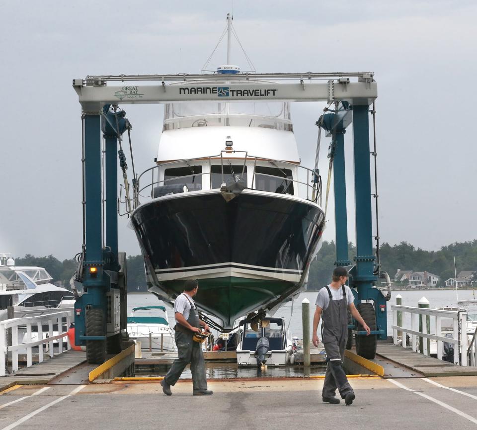 Workers at Great Bay Marine in Newington lift the boat Bay Dreamer from the water Wednesday, Sept. 13, 2023, in preparation for the potential impact of Hurricane Lee locally later in the week.