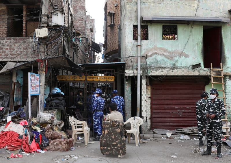 Paramilitary force stand guard at an alley after Wednesday's demolition of illegal encroachments in Jahangirpuri, in New Delhi