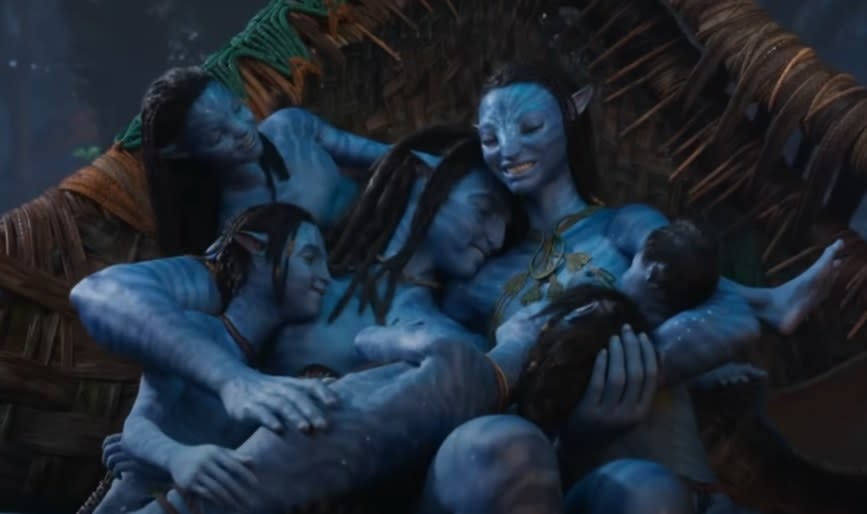 Sam Worthington and Zoe Saldana as Jake and Neytiri cuddling up with their kids