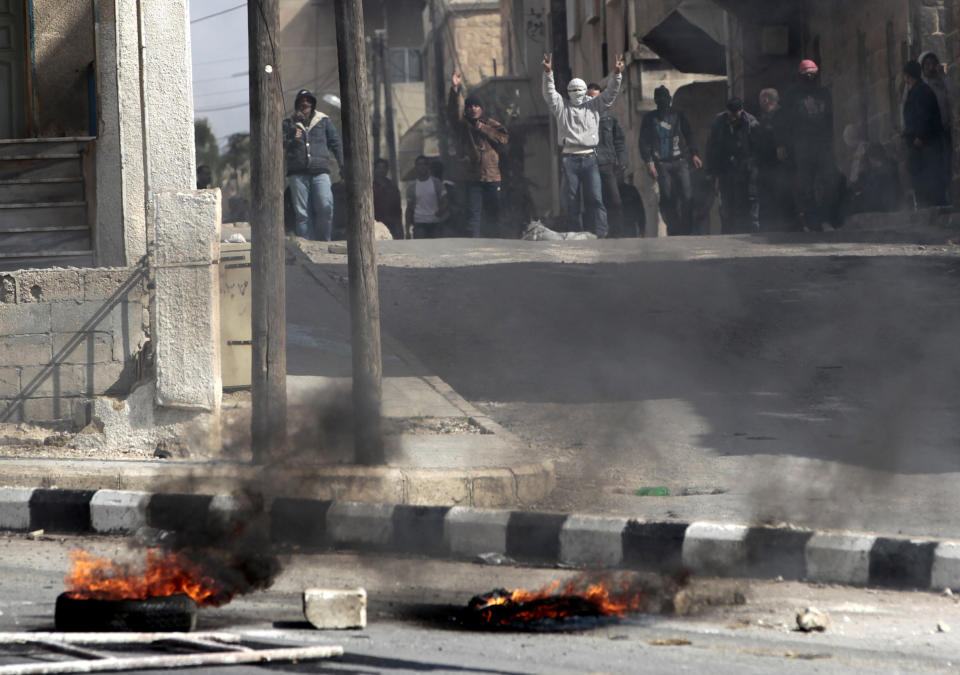 FILE - In this March 23, 2011, file photo, anti-government protesters flash victory signs in the southern city of Daraa, Syria. Security forces shot live ammunition and tear gas early that day near a mosque where protesters had been camped out, killing six people. After a decade of bloodshed, Daraa is back under Assad’s rule, but only tenuously. (AP Photo/Hussein Malla, File)