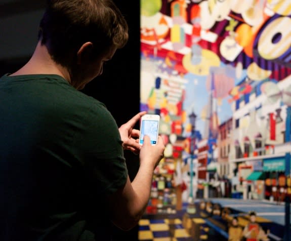 A gallery viewer uses Repentir to photograph Nathan Walsh's "Transamerica."