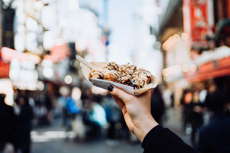 Someone holding Japanese street food in Osaka.