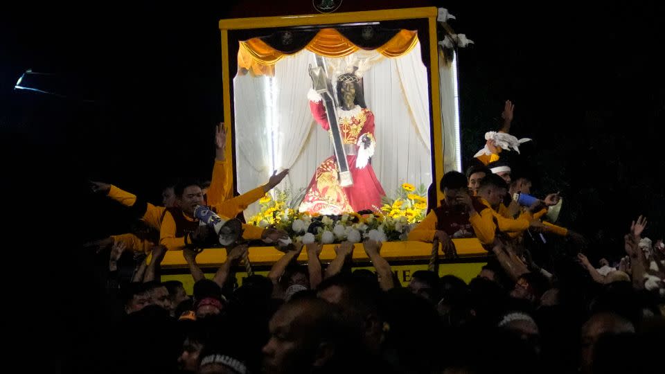 The Black Nazarene statue is paraded through downtown Manila. - Aaron Favila/AP