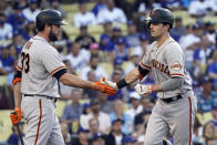 San Francisco Giants' Mike Yastrzemski, right, is met at home plate by Darin Ruf after Yastrzemski's solo home run during the first inning of the team's baseball game against the Los Angeles Dodgers on Wednesday, July 21, 2021, in Los Angeles. (AP Photo/Marcio Jose Sanchez)