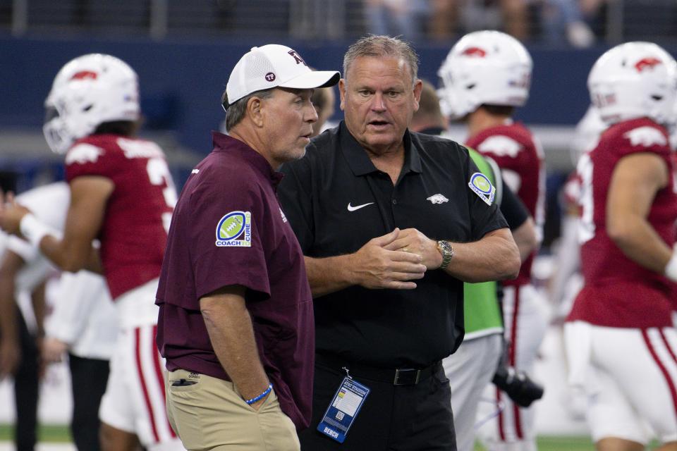 Sep 30, 2023; Arlington, Texas, USA; Texas A&M Aggies head coach Jimbo Fisher (left) talks with Arkansas Razorbacks head coach Sam Pittman (right) before the game between the Texas A&M Aggies and the Arkansas Razorbacks at AT&T Stadium. Mandatory Credit: Jerome Miron-USA TODAY Sports