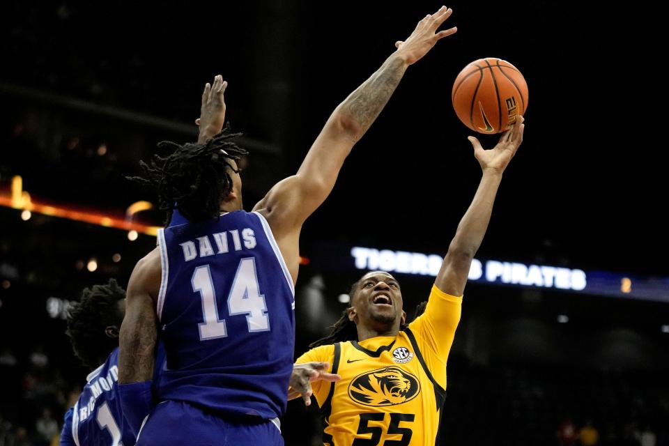 Missouri guard Sean East II (55) shoots under pressure from Seton Hall guard Dre Davis (14) during the first half of an NCAA college basketball game Sunday, Dec. 17, 2023, in Kansas City, Mo. (AP Photo/Charlie Riedel)