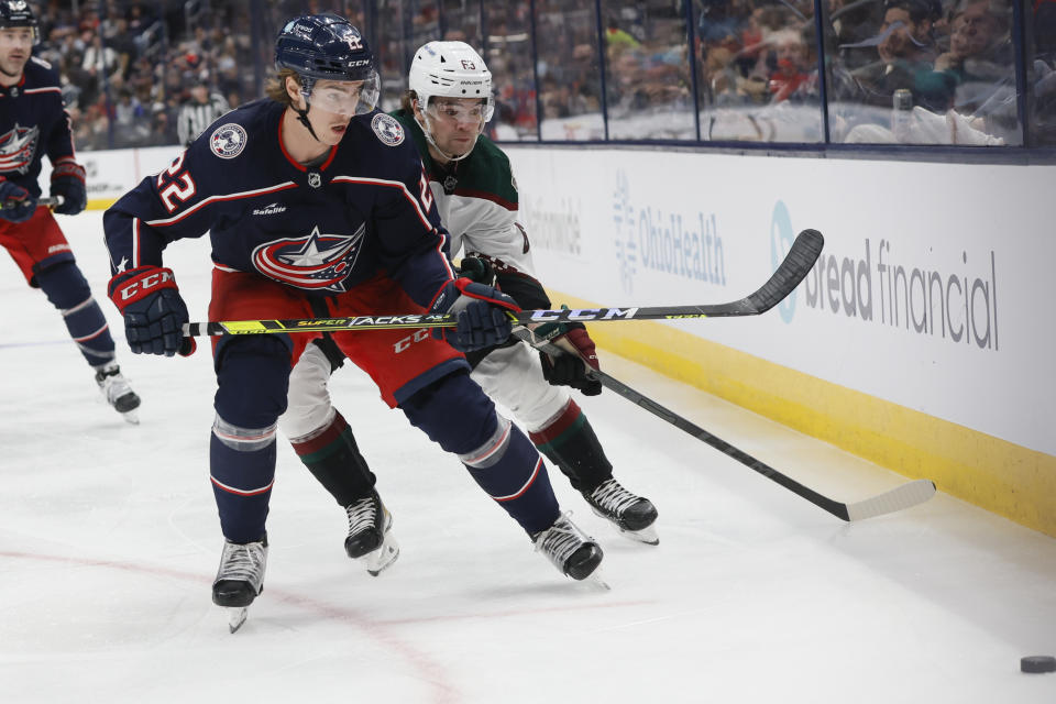 Columbus Blue Jackets' Jake Bean, left, and Arizona Coyotes' Matias Maccelli chase a loose puck during the third period of an NHL hockey game Tuesday, Oct. 25, 2022, in Columbus, Ohio. (AP Photo/Jay LaPrete)