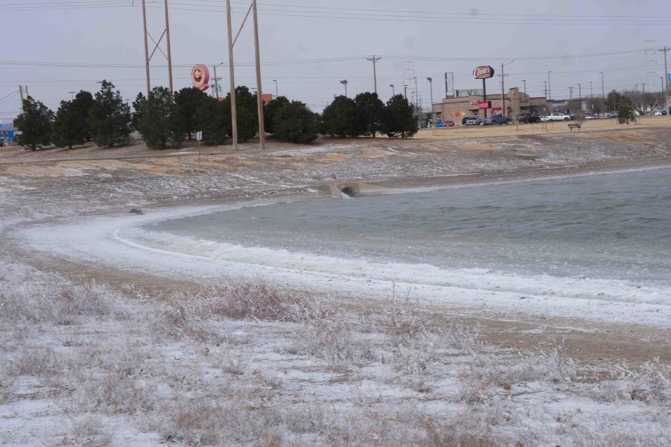 The reservoir at John Stiff Park with snow on ground is seen Thursday during a winter storm, which had temperatures around zero all through the Texas Panhandle.