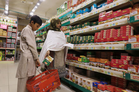 A woman shops for grocery items at a store in Peshawar, Pakistan April 3, 2019. Picture taken April 3, 2019. REUTERS/Fayaz Aziz/Files