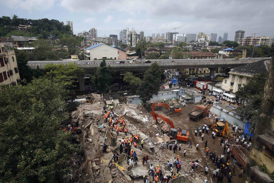 Rescue crews search for survivors at the site of a collapsed residential building in Mumbai September 27, 2013. The five-story apartment block collapsed on Friday in the Indian financial center of Mumbai, killing one person with dozens feared trapped in the latest accident to underscore shoddy building standards in Asia's third-largest economy. (REUTERS/Danish Siddiqui)