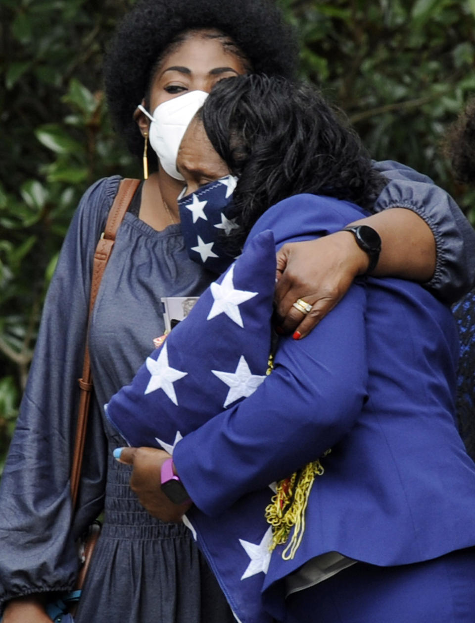 HFM*Annette Watkins, her face covered by a mask adorned with stars, holds a folded U.S. flag as she hugs a woman following the funeral of her son, Army veteran Damian Daniels, at Alabama National Cemetery in Montevallo, Ala., on Friday, Sept. 11, 2020. Daniels, an Alabama native who served in Afghanistan, was fatally shot by a sheriff's deputy at his home in San Antonio, Texas, last month. Relatives and authorities say he was troubled mentally. (AP Photo/Jay Reeves)