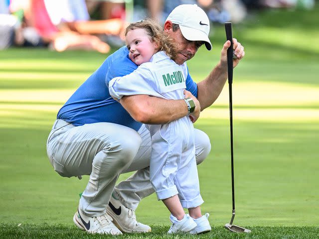 <p>Keyur Khamar/PGA TOUR/Getty</p> Rory McIlroy and his daughter Poppy on the ninth hole during the Par 3 Contest prior to the 2023 Masters Tournament.