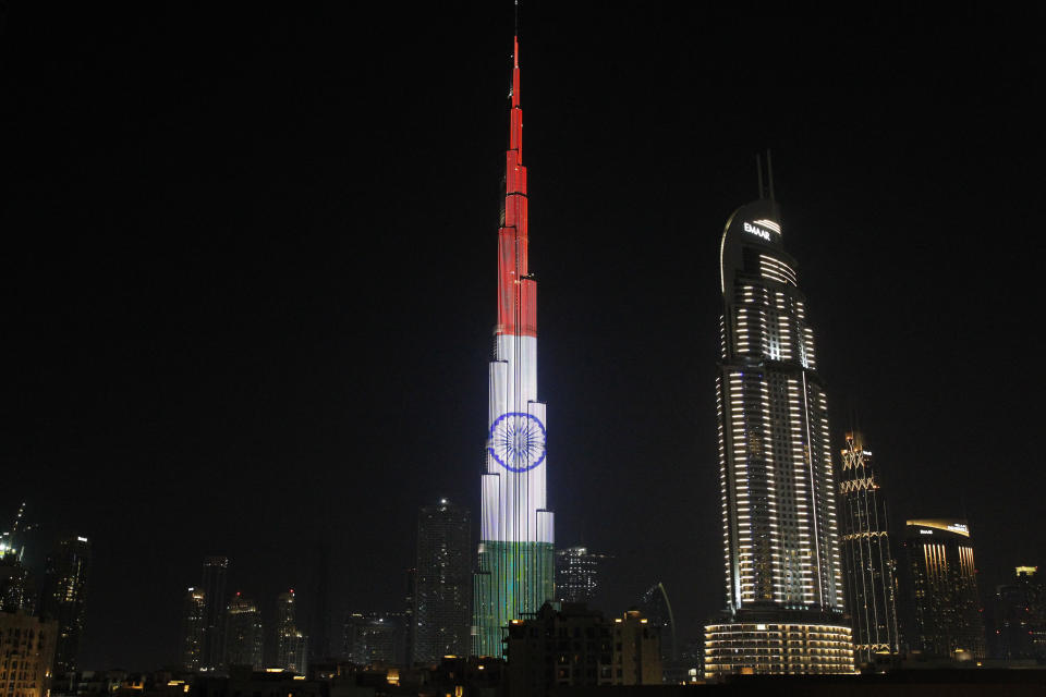 FILE - In this Feb. 10, 2018 file photo, the Burj Khalifa displays the flag of India to honor the visit of Indian Prime Minister Narendra Modi, in Dubai, United Arab Emirates. Gulf Arab countries have remained mostly silent as India’s government moved to strip the Indian-administered sector of Kashmir of its limited autonomy, imposing a sweeping military curfew in the disputed Muslim-majority region and cutting off residents from all communication and the internet. This muted response is underwritten by more than $100 billion in annual trade with India that makes it one of the Arabian Peninsula’s most prized economic partners. (AP Photo/Jon Gambrell, File)