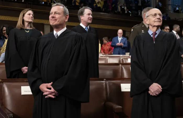 Supreme Court justices stand during the state of the uniuon