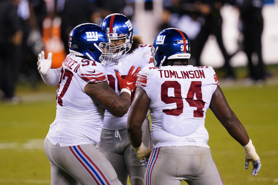 New York Giants' Dexter Lawrence (97), Leonard Williams (99) and Dalvin Tomlinson (94) celebrate after stopping a two-point conversion attempt by the Philadelphia Eagles during the second half of an NFL football game, Thursday, Oct. 22, 2020, in Philadelphia. (AP Photo/Chris Szagola)