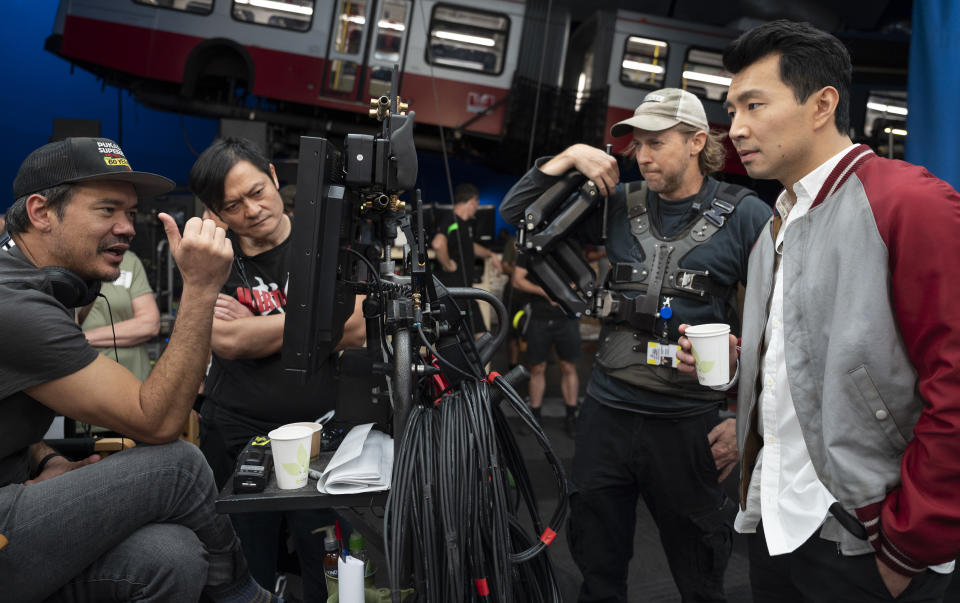 Director Destin Daniel Cretton, fight instructor Alan Tang, crew camera operator, and Simu Liu on the set of Marvel Studios' Shang-Chi and the Legend of the Ten Rings. (Photo by Jasin Boland/Marvel Studios)