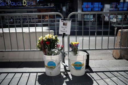 Flowers and a photograph of Alyssa Elsman, the 18-year-old woman who was killed when a speeding vehicle struck pedestrians on the sidewalk Thursday is seen at a makeshift memorial at the scene of the incident outside the 3 Times Square building in Times Square in New York City, U.S., May 19, 2017. REUTERS/Mike Segar