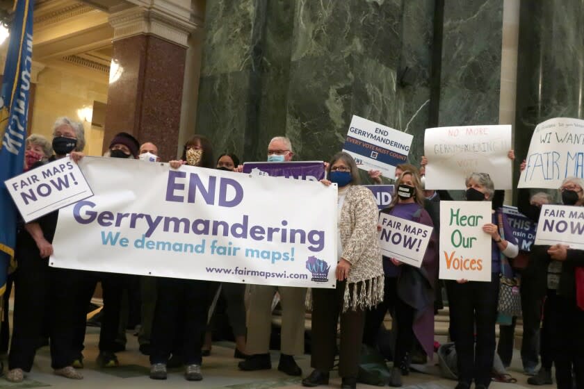 FILE - More than 100 opponents of the Republican redistricting plans vow to fight the maps at a rally ahead of a joint legislative committee hearing at the Wisconsin state Capitol in Madison, Wis., on Thursday, Oct. 28, 2021. In overturning a half-century of nationwide legal protection for abortion, the U.S. Supreme Court ruled that Roe v. Wade had been wrongly decided and that it was time to "return the issue of abortion to the people's elected representatives" in the states. But some question whether gerrymandering has diminished the ability of state legislatures to truly represent the people's will. (AP Photo/Scott Bauer, File)