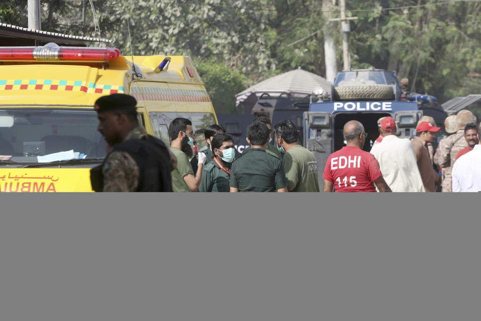 Pakistani volunteers gather outside the Chinese Consulate in Karachi, Pakistan, Friday, Nov. 23, 2018. Pakistani police say gunmen have stormed the Chinese Consulate in the country's southern port city of Karachi, triggering an intense shootout. (AP Photo/Shakil Adil)