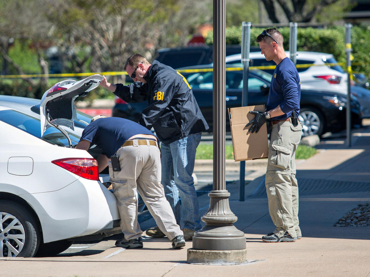 FBI agents are seen carrying items out in paper bags and boxes at a FedEx shop in Austin, Texas: EPA