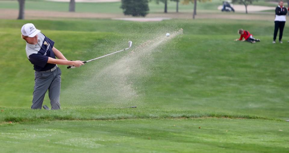 Tea Area's Brady Sabers chips out of the bunker Tuesday during the final round of the Class A boys golf state tournament Tuesday in Aberdeen.