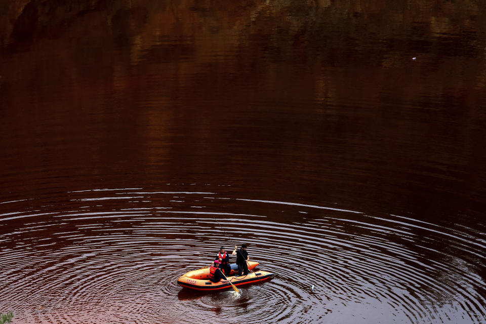 Members of the Cyprus Special Disaster Response Unit search for suitcases in a man-made lake, near the village of Mitsero outside of the capital Nicosia, Cyprus, Wednesday, May 1, 2019. Cyprus police spokesman Andreas Angelides says British experts called in to assist in the east Mediterranean island nation's serial killer case have been brought up to speed on the ongoing probe. (AP Photo/Petros Karadjias) (AP Photo/Petros Karadjias)