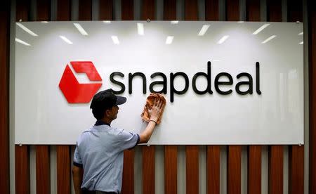 FILE PHOTO: An employee cleans a Snapdeal logo at its headquarters in Gurugram on the outskirts of New Delhi, India, April 3, 2017. REUTERS/Adnan Abidi/File photo