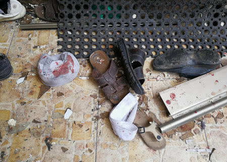 Slippers and a hat stained with blood are seen following a twin bombing inside a mosque in Benghazi, Libya February 9, 2018. REUTERS/Stringer