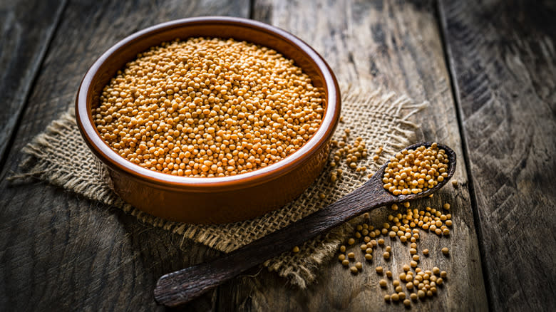 Bowl of mustard seeds with spoon