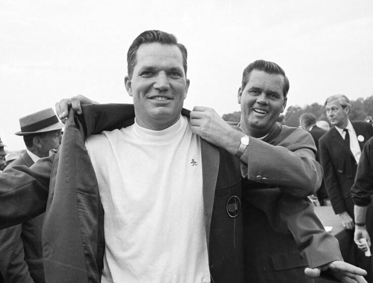 Bob Goalby puts on the traditional green jacket as champion of the Masters in 1968