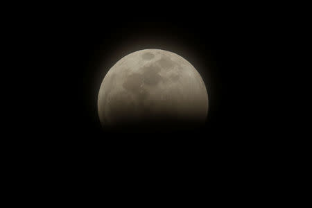 The start of a total lunar eclipse that is being called a 'Super Blood Wolf Moon' is shown from Encinitas, California, U.S., January 20, 2019. REUTERS/Mike Blake