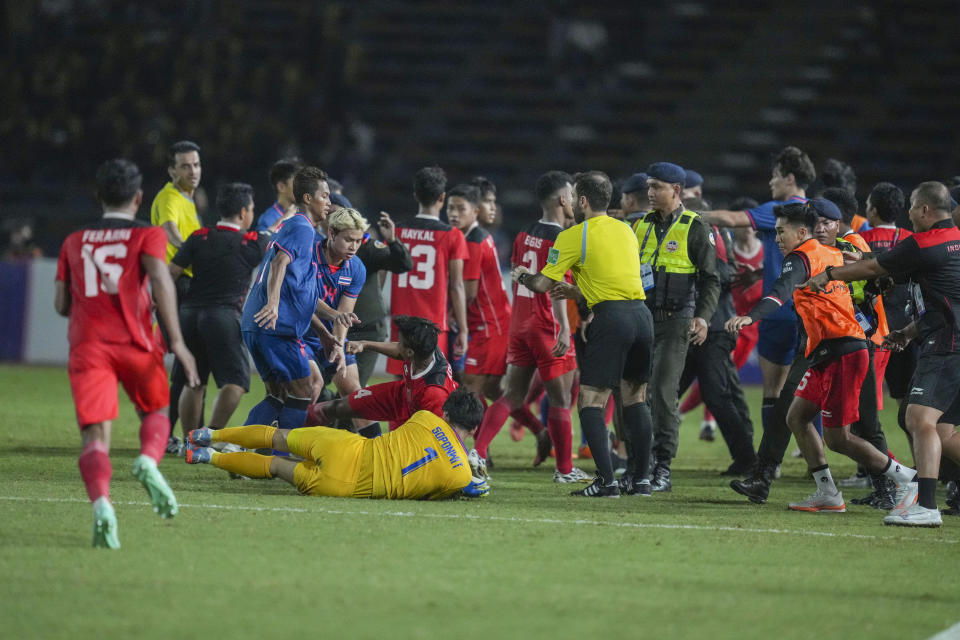 Thailand's team clash with Indonesia players during the men's final soccer match at the 32nd Southeast Asian Games in Phnom Penh, Cambodia, Tuesday, May 16, 2023. (AP Photo/Tatan Syuflana)