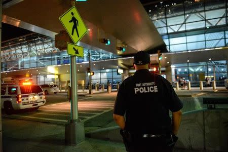 Members of the Port Authority Police Department stand guard at Terminal 8 at John F. Kennedy airport in the Queens borough of New York City, August 14, 2016. REUTERS/Stephanie Keith