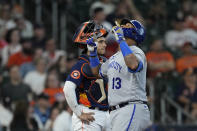 Kansas City Royals' Salvador Perez (13) celebrates after hitting a home run as Houston Astros catcher Yainer Diaz stands behind home plate during the third inning of a baseball game Sunday, Sept. 24, 2023, in Houston. (AP Photo/David J. Phillip)