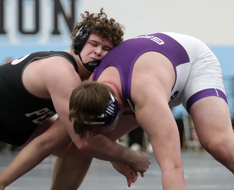 Perry's Aidan Fockler, left, works to take down Fremont Ross' Ethan Green during their 285 pound semifinal match in the Division I OHSAA State Wrestling Tournament at Hilliard Darby High School, Sunday, March 14, 2021, in Hilliard, Ohio. [Jeff Lange/Beacon Journal]