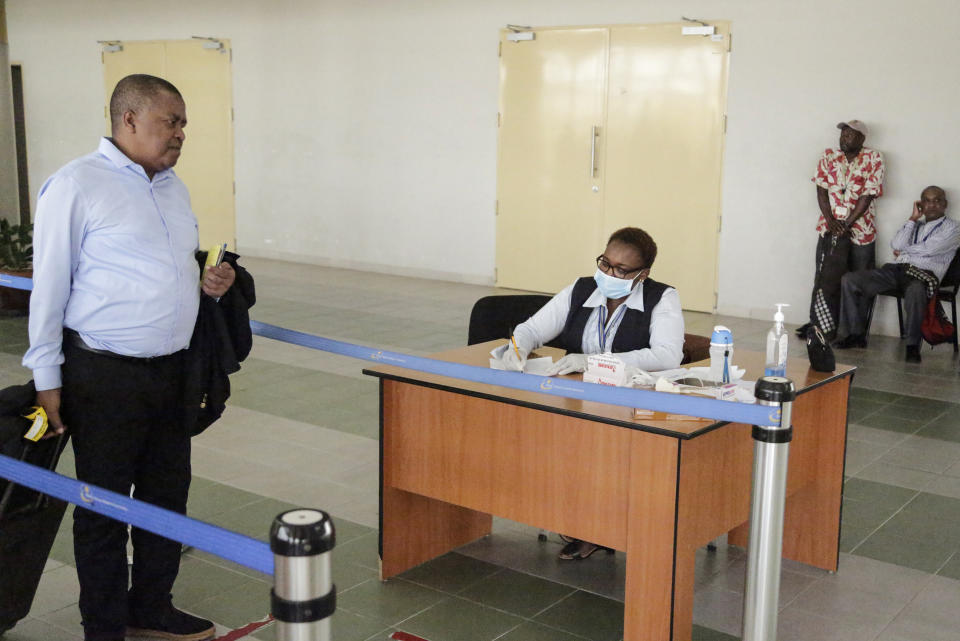 Travellers are screened for symptoms of Ebola upon their arrival at the Jomo Kenyatta International Airport in Nairobi, Kenya Monday, June 17, 2019. Kenyan doctors are testing a hospital patient in western Kenya who has Ebola-like symptoms, as eastern Congo is struggling to control the outbreak and Uganda has reported two deaths from the deadly hemorrhagic fever, though Kenya's health minister downplayed the threat Monday. (AP Photo/Khalil Senosi)