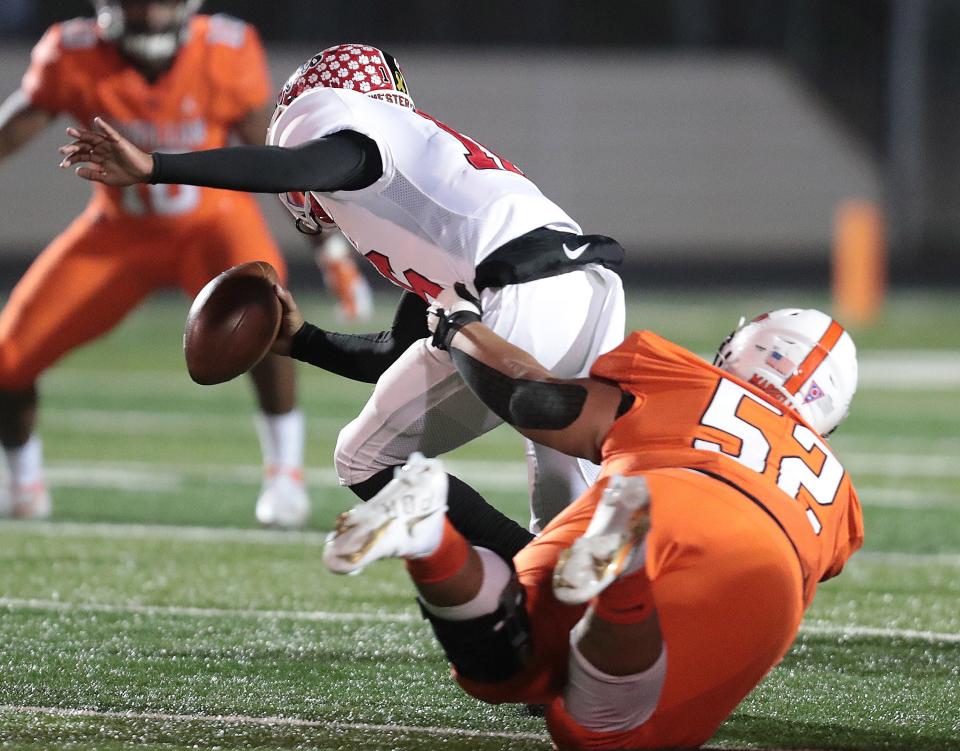 Massillon defensive lineman Marcus Moore sacks Westerville South quarterback Dominic Birtha in the second half  at Massillon during this regional quarterfinal playoff game Friday, November 5, 2021. 