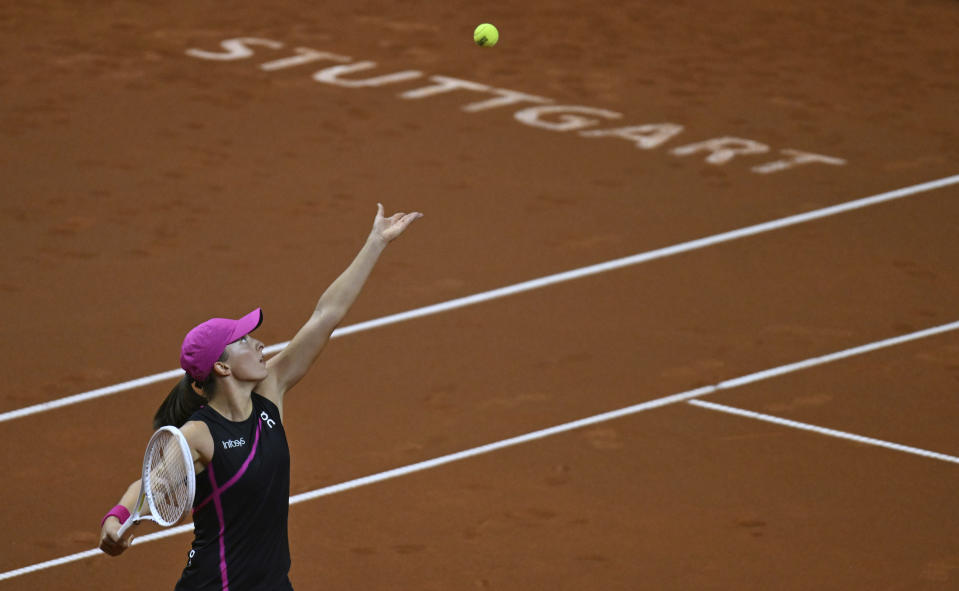 Poland's Iga Swiatek serves to Belgium's Elise Mertens during the women's singles round of 16 tennis match at the WTA Tour in Stuttgart, Germany, Thursday April 18, 2024. (Marijan Murat/dpa via AP)