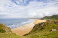 <p>Rhossili Bay in the Gower was voted the best beach in the UK in 2010, and unsurprisingly has made the list regularly ever since. It's three miles long, and welcomes dogs, hikers, families and surfers.</p><p><a class="link " href="https://www.booking.com/" rel="nofollow noopener" target="_blank" data-ylk="slk:FIND ACCOMMODATION;elm:context_link;itc:0;sec:content-canvas">FIND ACCOMMODATION </a></p>