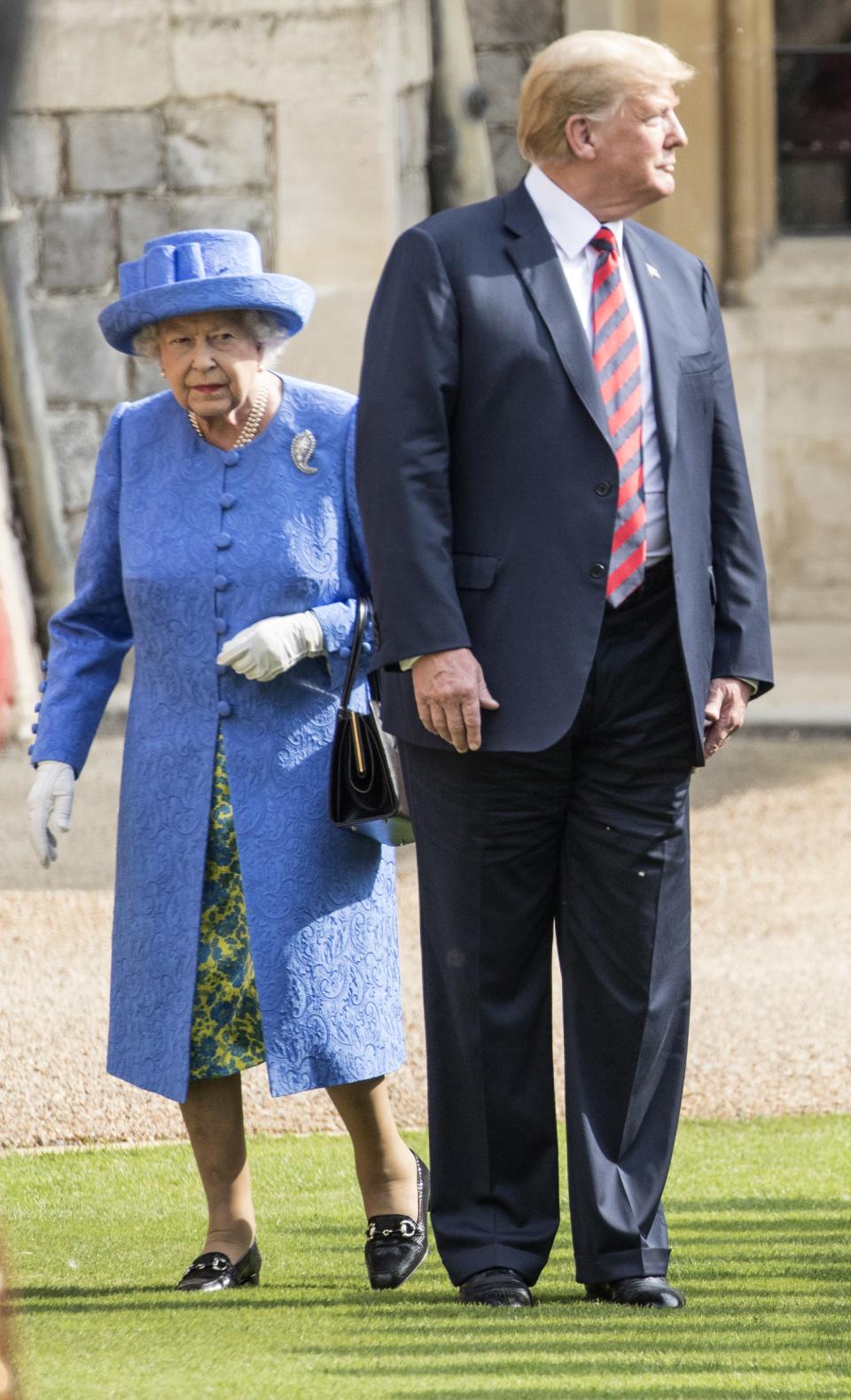 President Donald Trump and Queen Elizabeth II inspect a Guard of Honour on the Quadrangle at Windsor Castle after which he and first lady Melania Trump joined Her Majesty for tea at the castle, on July 13, 2018.