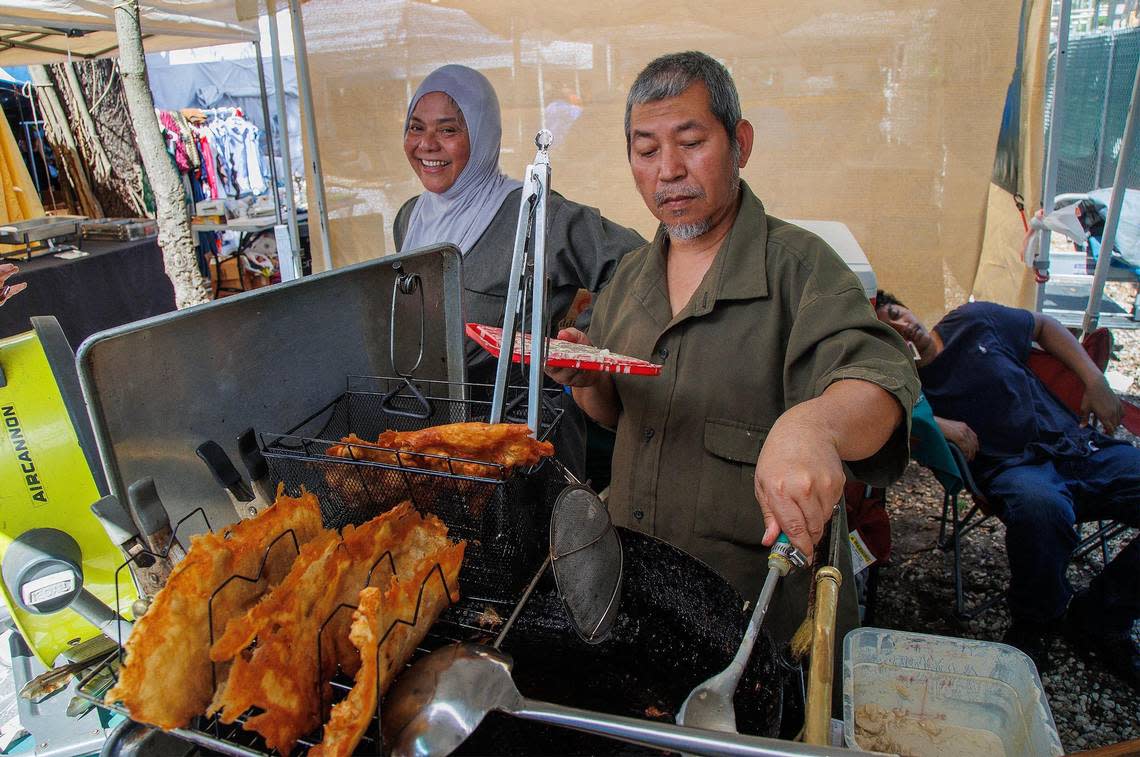 Jack Moten fries up cauliflower as Erva Moten sells their vegan Indonesian food, on Saturday, August 12, 2023.