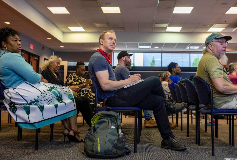 Stephanie Minnis, left, Ben Dueweke, center, and Bill Cheek sit inside the Wayne County Community College District downtown campus during a general summer meeting organized by the North Corktown Neighborhood Association in Detroit on Saturday, June 1, 2024.