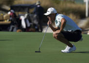 Collin Morikawa of the United States, studies his putt on the third hole during a Pro-Am tournament ahead of the Hero World Challenge PGA Tour at the Albany Golf Club, in New Providence, Bahamas, Wednesday, Dec. 1, 2021. (AP Photo/Fernando Llano)