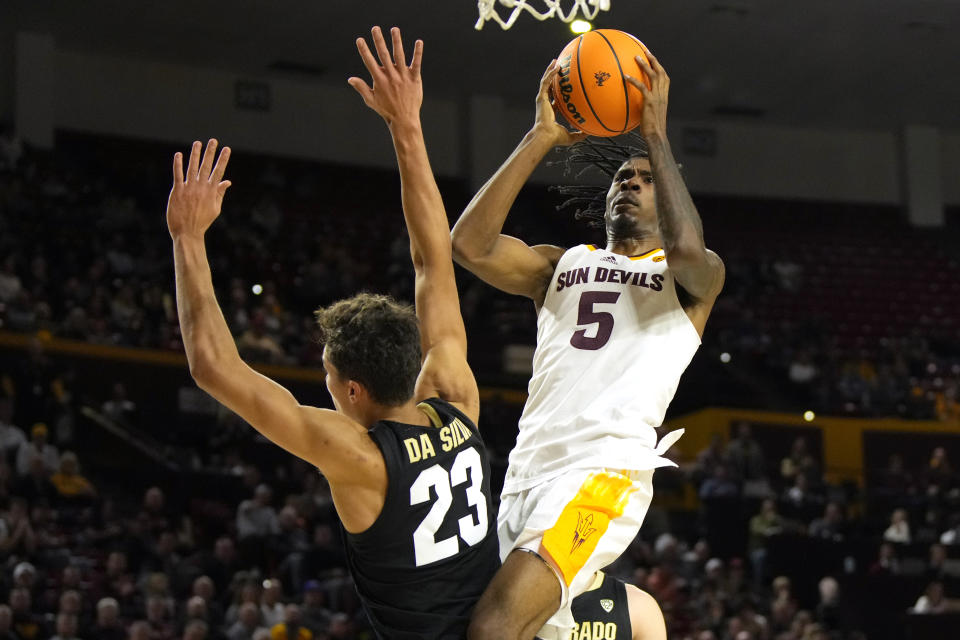 Arizona State guard Jamiya Neal (5) goes up to shoot over Colorado forward Tristan da Silva (23) during the second half of an NCAA college basketball game, Saturday, Jan. 6, 2024, in Tempe, Ariz. (AP Photo/Rick Scuteri)