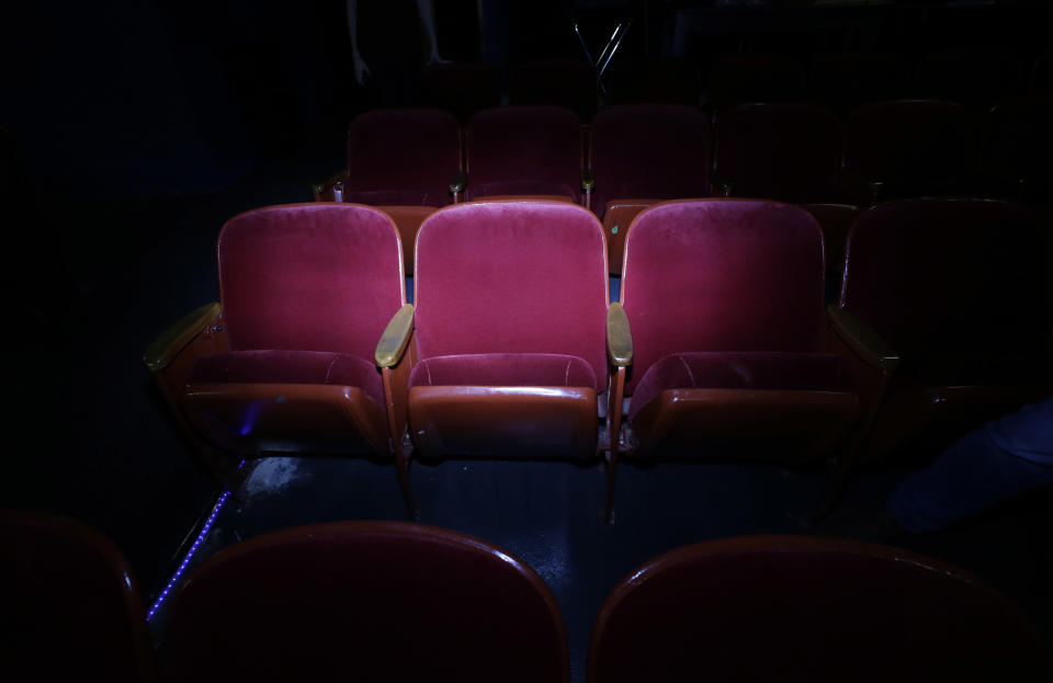 In this photo made Thursday, Oct. 31, 2013, the seat that Lee Harvey Oswald was sitting in when Dallas Police arrested him is illuminated at the Texas Theatre in the Oak Cliff section of Dallas. Oswald was arrested here on Nov. 22, 1963, after the assassination of President John F. Kennedy. (AP Photo/LM Otero)