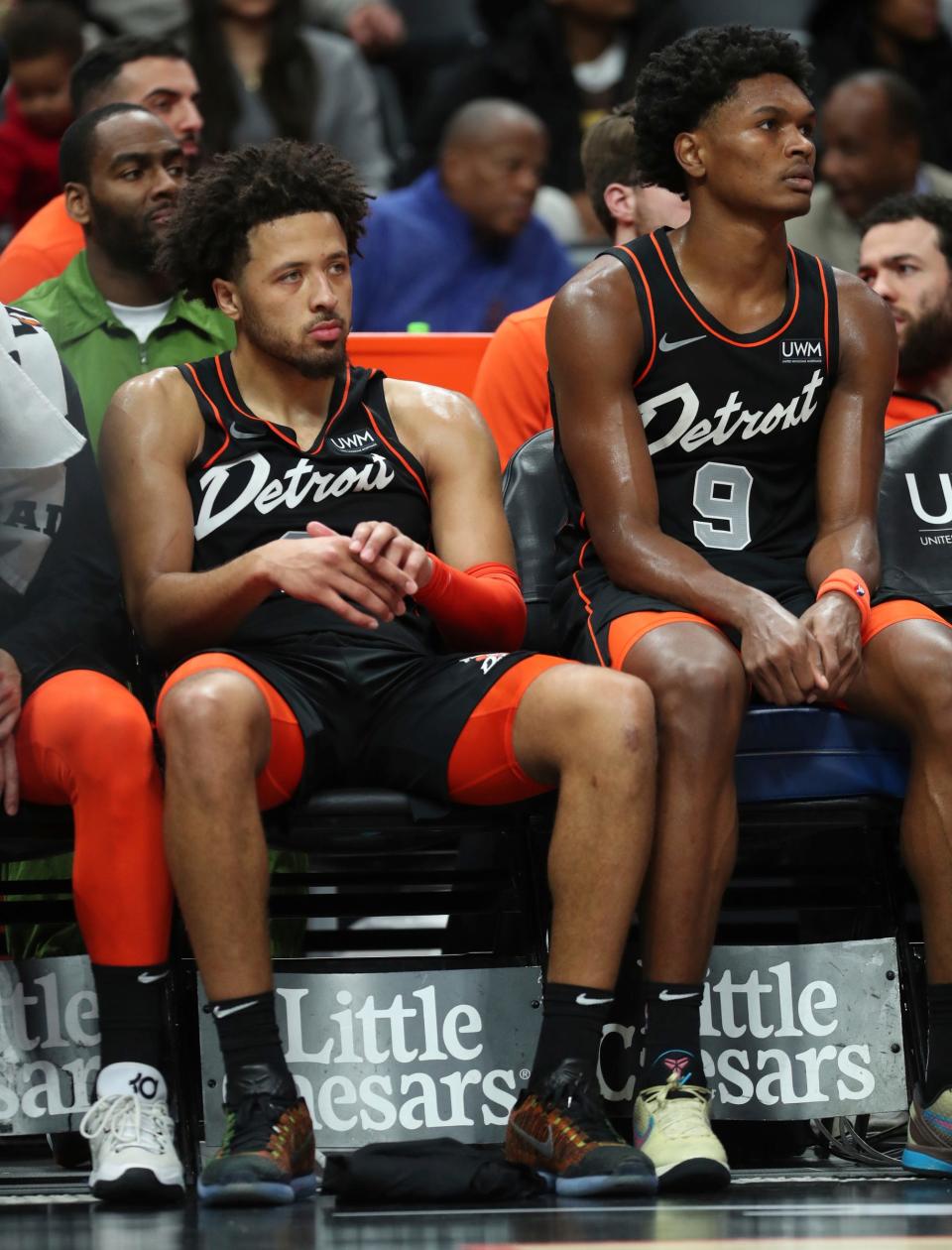 Detroit Pistons guard Cade Cunningham (2) and forward Ausar Thompson (9) sit on the bench during a loss against the Phoenix Suns at Little Caesars Arena in Detroit on Sunday, Nov. 5, 2023.