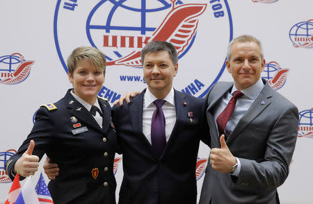 Crew members of the International Space Station (ISS) next mission David Saint-Jacques (R) of Canada, Oleg Kononenko (C) of Russia and Anne McClain of the U.S. pose for a picture during a news conference in Star City near Moscow, Russia November 15, 2018. REUTERS/Maxim Shemetov