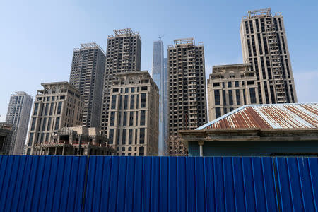 High-rises developed by Goldin Properties stand partially empty in Tianjin's high-tech zone, China, May 25, 2018. The Goldin Finance 117 landmark skysraper that is under construction is seen in the background. REUTERS/Yawen Chen